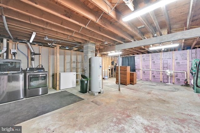 unfinished below grade area featuring water heater, washer and clothes dryer, and fridge