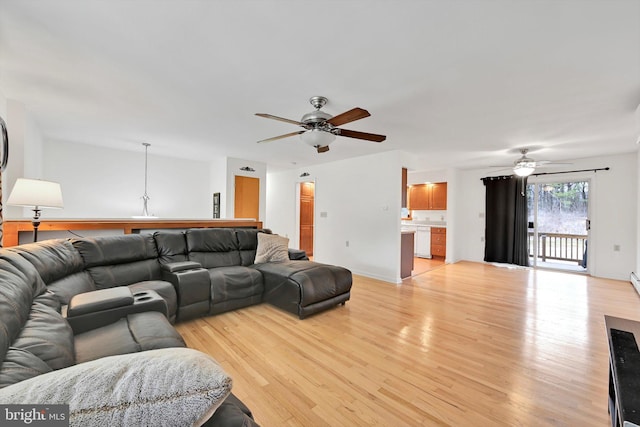 living area with light wood-type flooring and ceiling fan