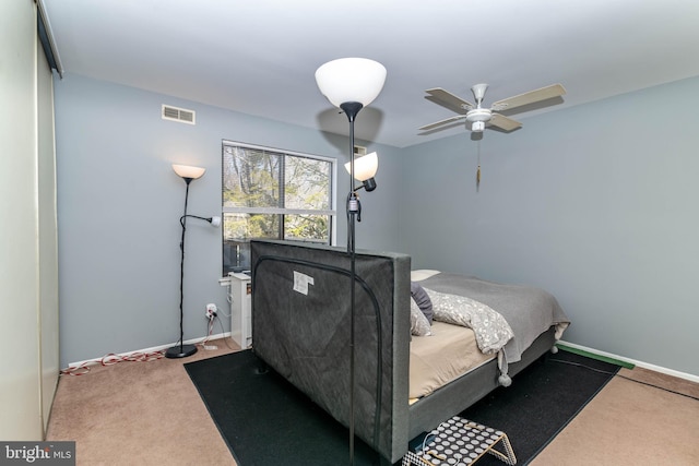 bedroom featuring visible vents, baseboards, carpet, and a ceiling fan