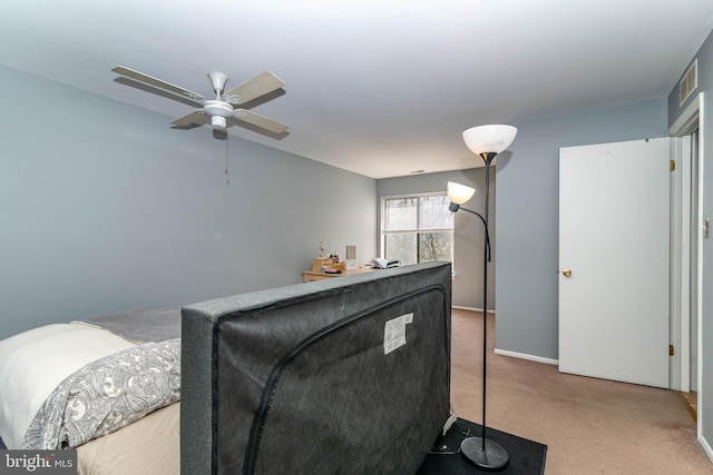 carpeted bedroom with visible vents, baseboards, and ceiling fan