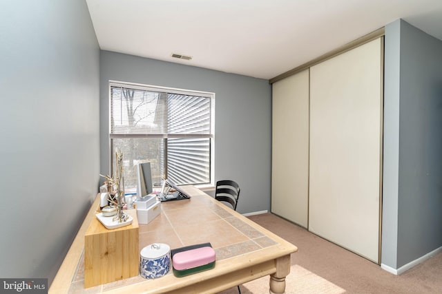 office with visible vents, light carpet, and baseboards