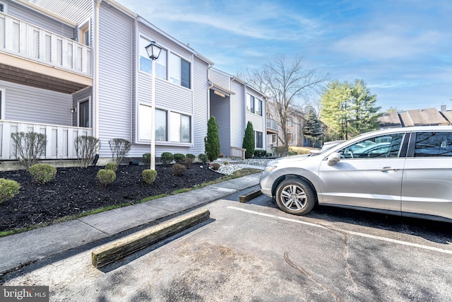 view of side of property with a residential view and uncovered parking