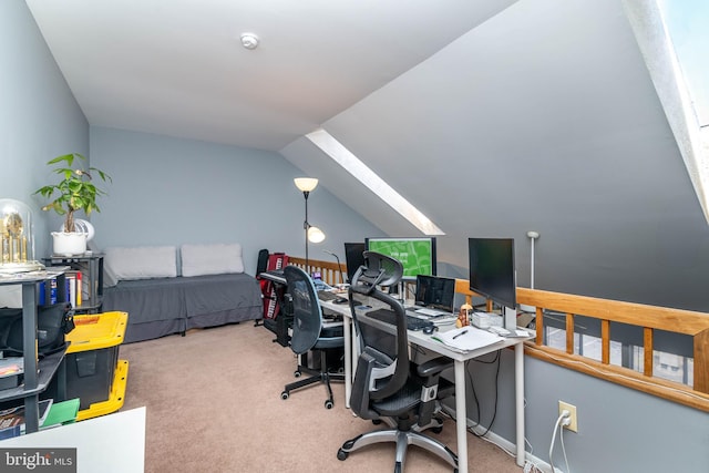 office featuring vaulted ceiling with skylight and carpet flooring