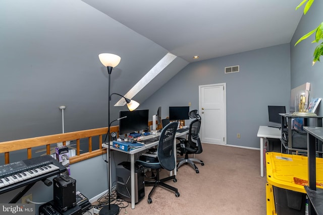 carpeted office space with vaulted ceiling, baseboards, and visible vents