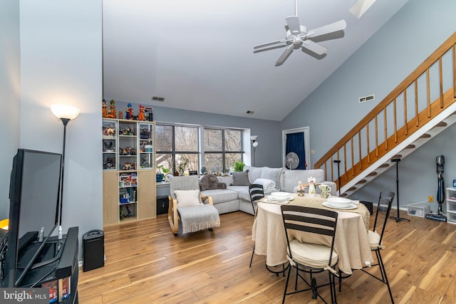 living room featuring hardwood / wood-style flooring, stairway, and visible vents