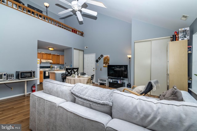 living room featuring baseboards, dark wood-type flooring, ceiling fan, and high vaulted ceiling