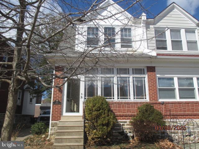 view of front of home featuring brick siding and entry steps