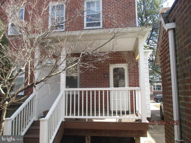 doorway to property with brick siding