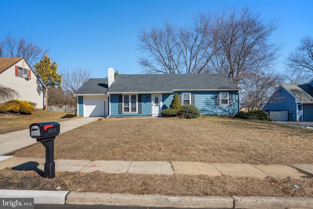 ranch-style home with a garage, a front lawn, concrete driveway, and a chimney