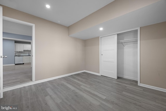 unfurnished bedroom with baseboards and wood finished floors