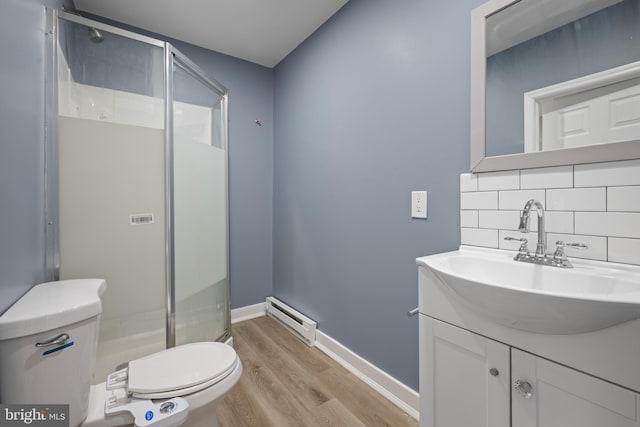 bathroom featuring a baseboard radiator, toilet, a shower stall, and decorative backsplash