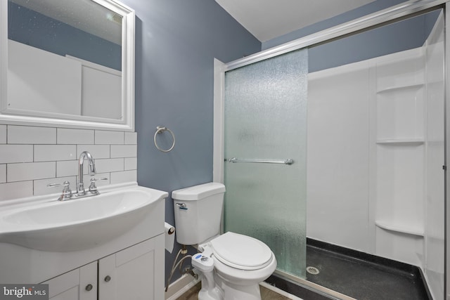 bathroom with decorative backsplash, toilet, vanity, and a stall shower