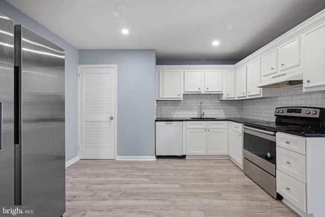 kitchen featuring a sink, white cabinets, under cabinet range hood, and stainless steel appliances