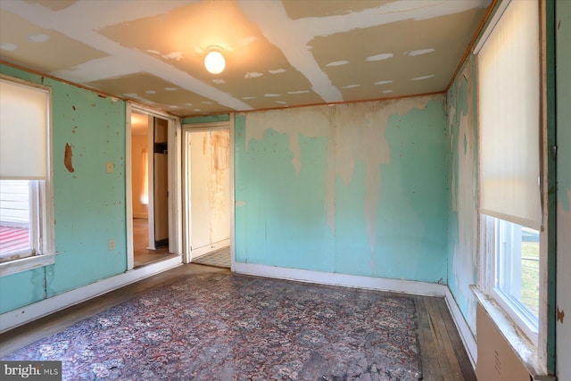 spare room featuring wood finished floors