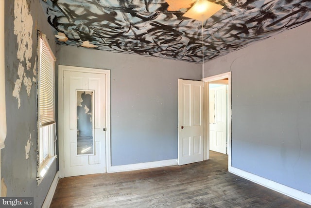 unfurnished bedroom featuring wood finished floors and baseboards