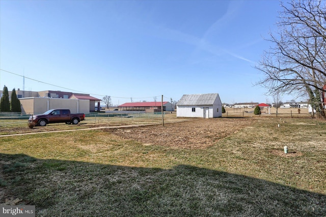 view of yard with an outbuilding and fence