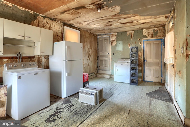 kitchen featuring washer / dryer, white cabinets, freestanding refrigerator, and a baseboard radiator