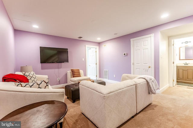 living area featuring recessed lighting, light colored carpet, visible vents, and baseboards