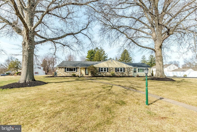 view of front of property featuring a front yard and stone siding