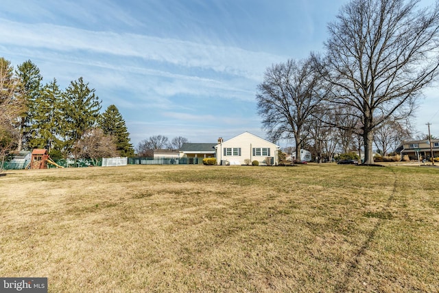 view of yard with a playground and fence