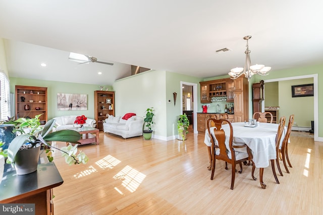 dining room featuring visible vents, baseboards, light wood-type flooring, recessed lighting, and ceiling fan with notable chandelier