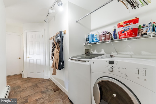 laundry area with stone finish flooring, a baseboard radiator, laundry area, and washer and clothes dryer