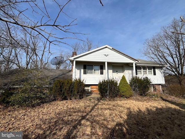 view of front of house featuring a chimney