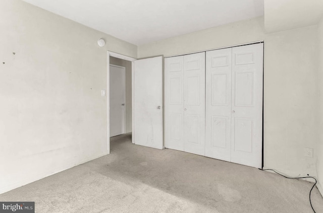 unfurnished bedroom featuring a closet and carpet