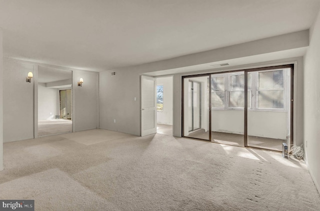 unfurnished bedroom with visible vents and carpet floors