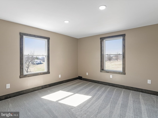 carpeted empty room featuring recessed lighting, a healthy amount of sunlight, and baseboards