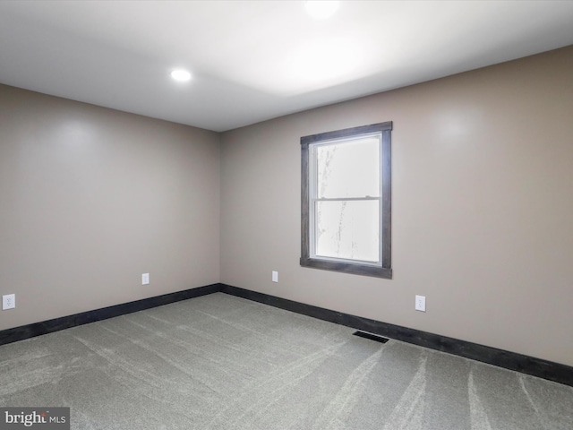 empty room featuring recessed lighting, visible vents, carpet floors, and baseboards