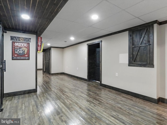 spare room featuring recessed lighting, a paneled ceiling, baseboards, and wood finished floors