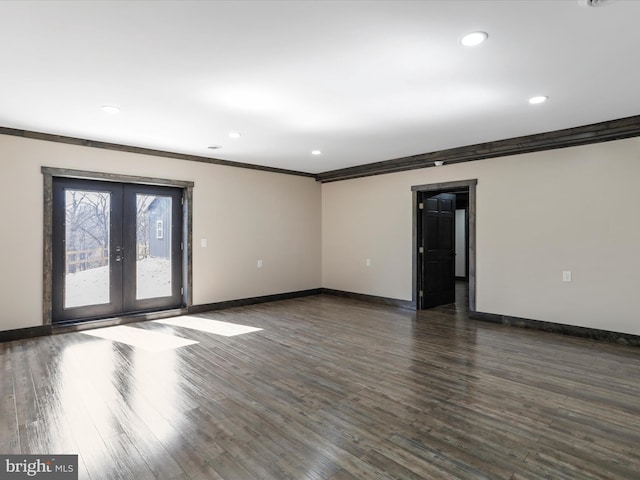 empty room featuring dark wood-style floors, french doors, and baseboards