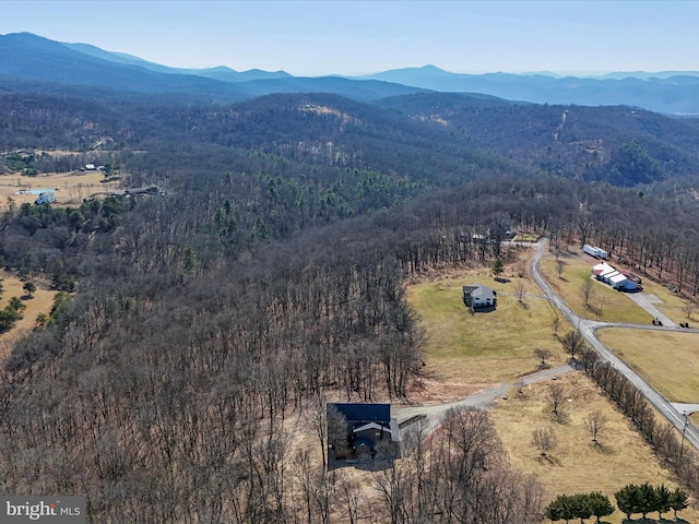 drone / aerial view with a wooded view, a rural view, and a mountain view