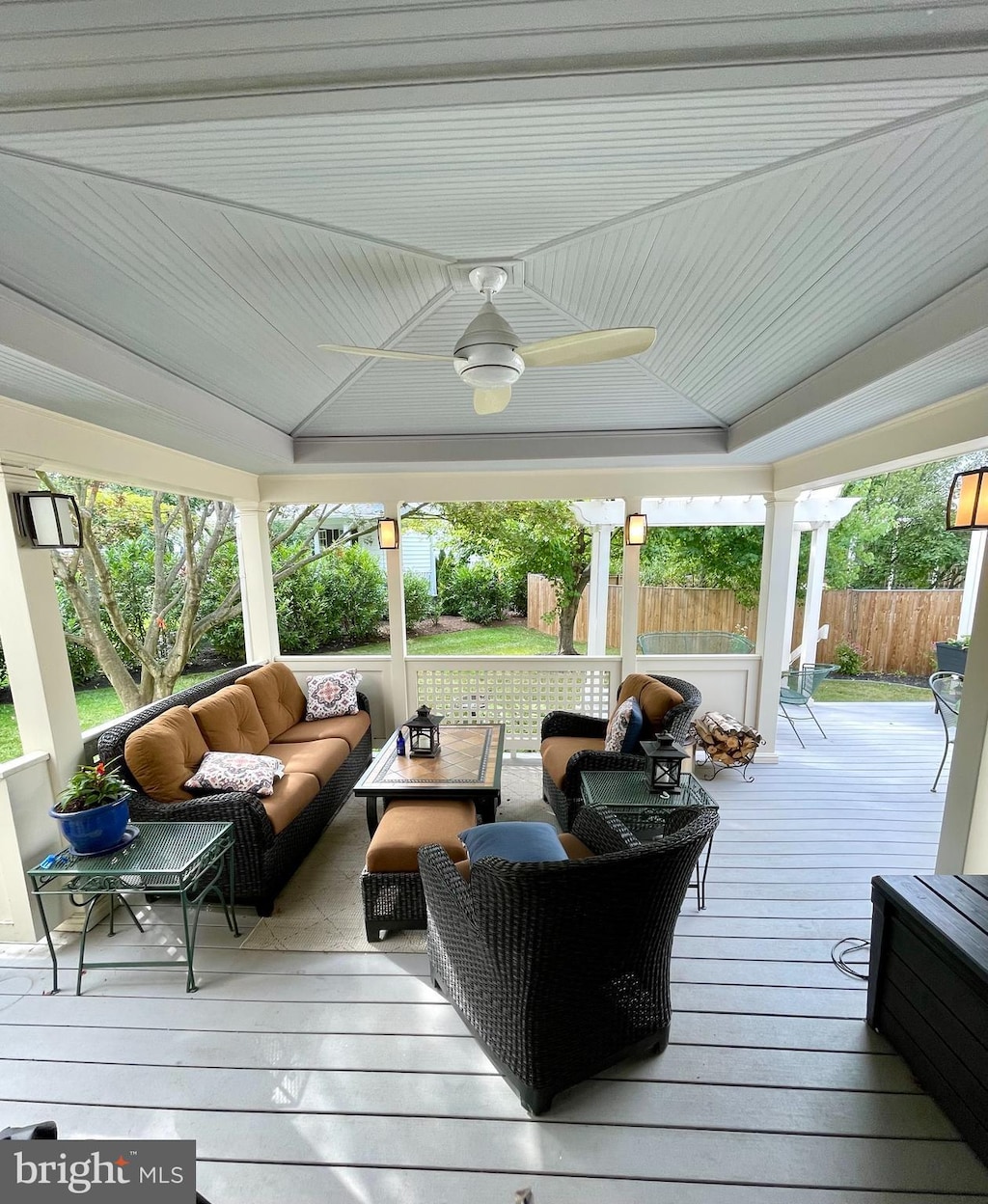 wooden deck featuring an outdoor hangout area, ceiling fan, and fence