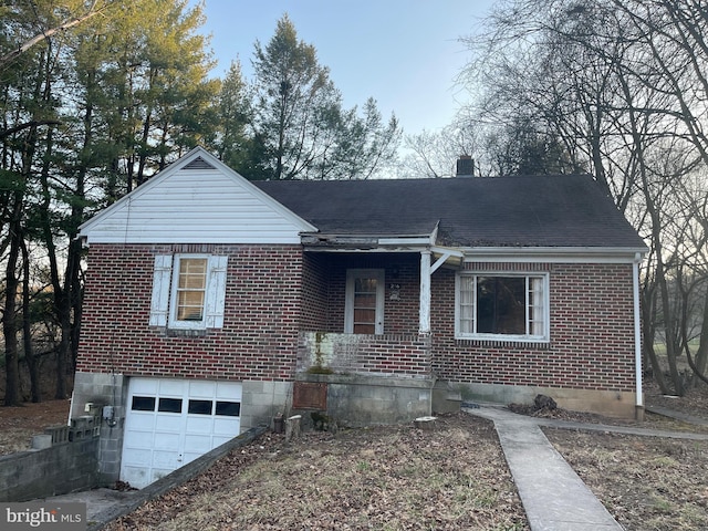 view of front of home with a garage, brick siding, a chimney, and a shingled roof