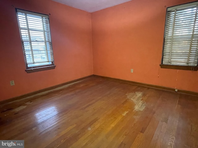 empty room with wood finished floors and baseboards