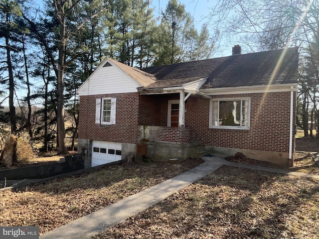 view of front of home featuring a garage, brick siding, roof with shingles, and a chimney