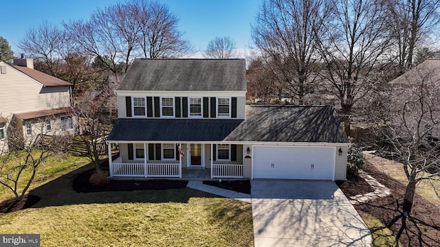 view of front of house with concrete driveway, a porch, a garage, and a front yard