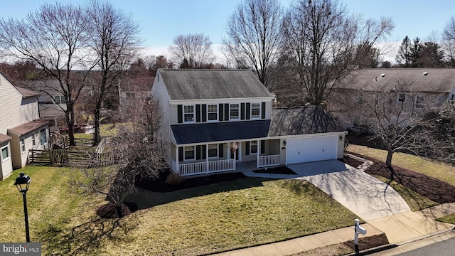 view of front of house with a garage, a front lawn, concrete driveway, and a porch