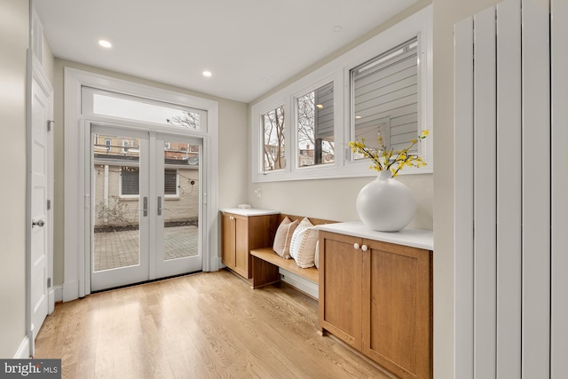 doorway to outside with recessed lighting, french doors, and light wood-type flooring