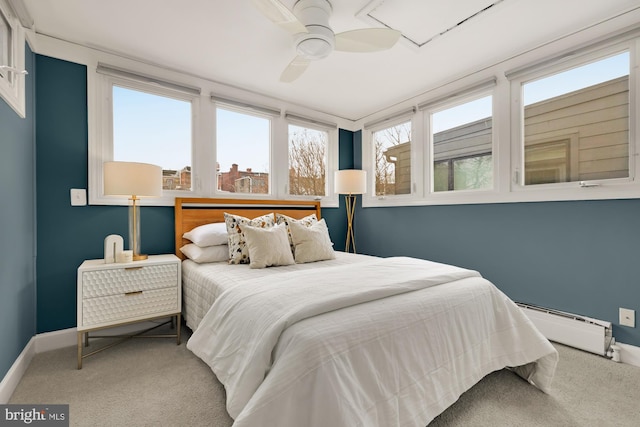 bedroom with carpet flooring, baseboards, baseboard heating, and ceiling fan