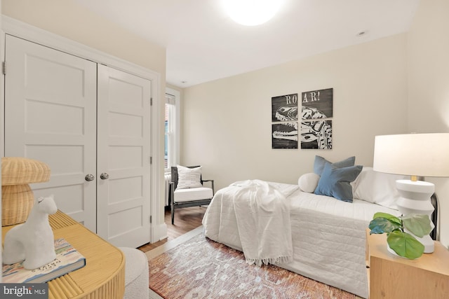 bedroom with a closet and wood finished floors