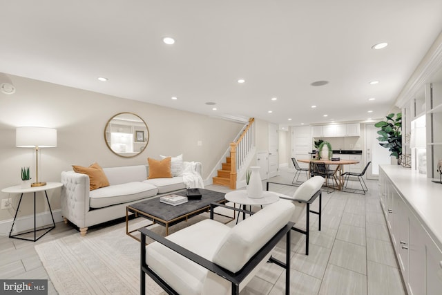 living room with stairs, recessed lighting, and baseboards