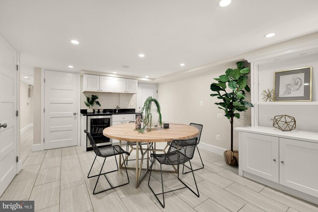 dining area with recessed lighting, wine cooler, and wet bar