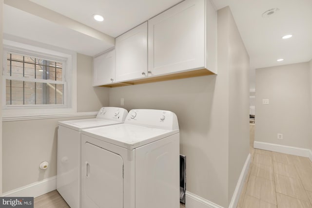 clothes washing area featuring cabinet space, recessed lighting, separate washer and dryer, and baseboards