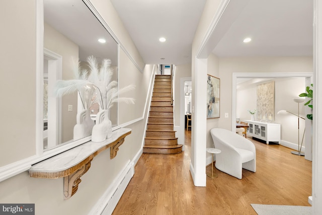 stairs featuring recessed lighting, wood finished floors, and baseboards