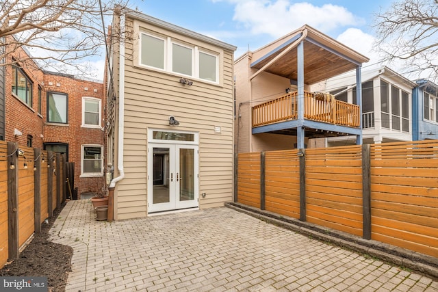 rear view of property with french doors, a fenced backyard, and a patio