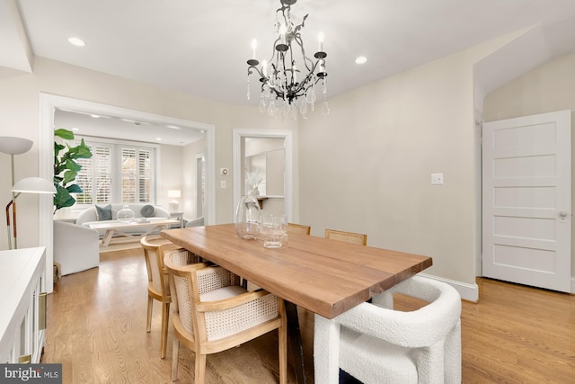 dining room with a notable chandelier, recessed lighting, light wood-type flooring, and baseboards