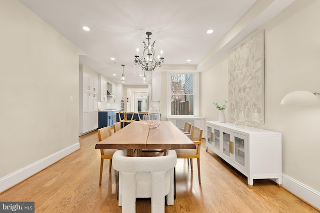 dining room featuring recessed lighting, baseboards, an inviting chandelier, and light wood-style flooring